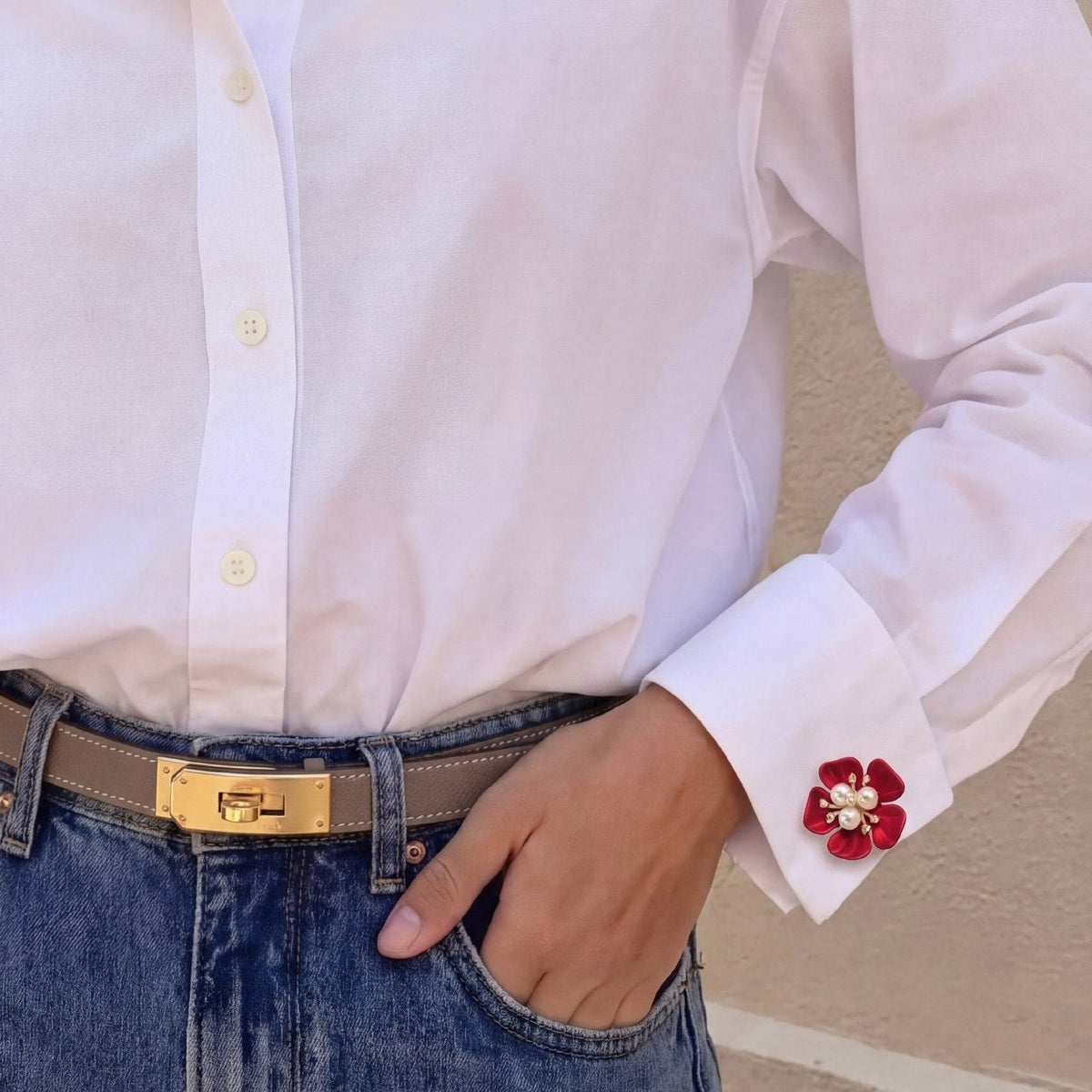 Refined by JV crimson flower button cover with pearl center attached to a white shirt cuff for a glamorous look
