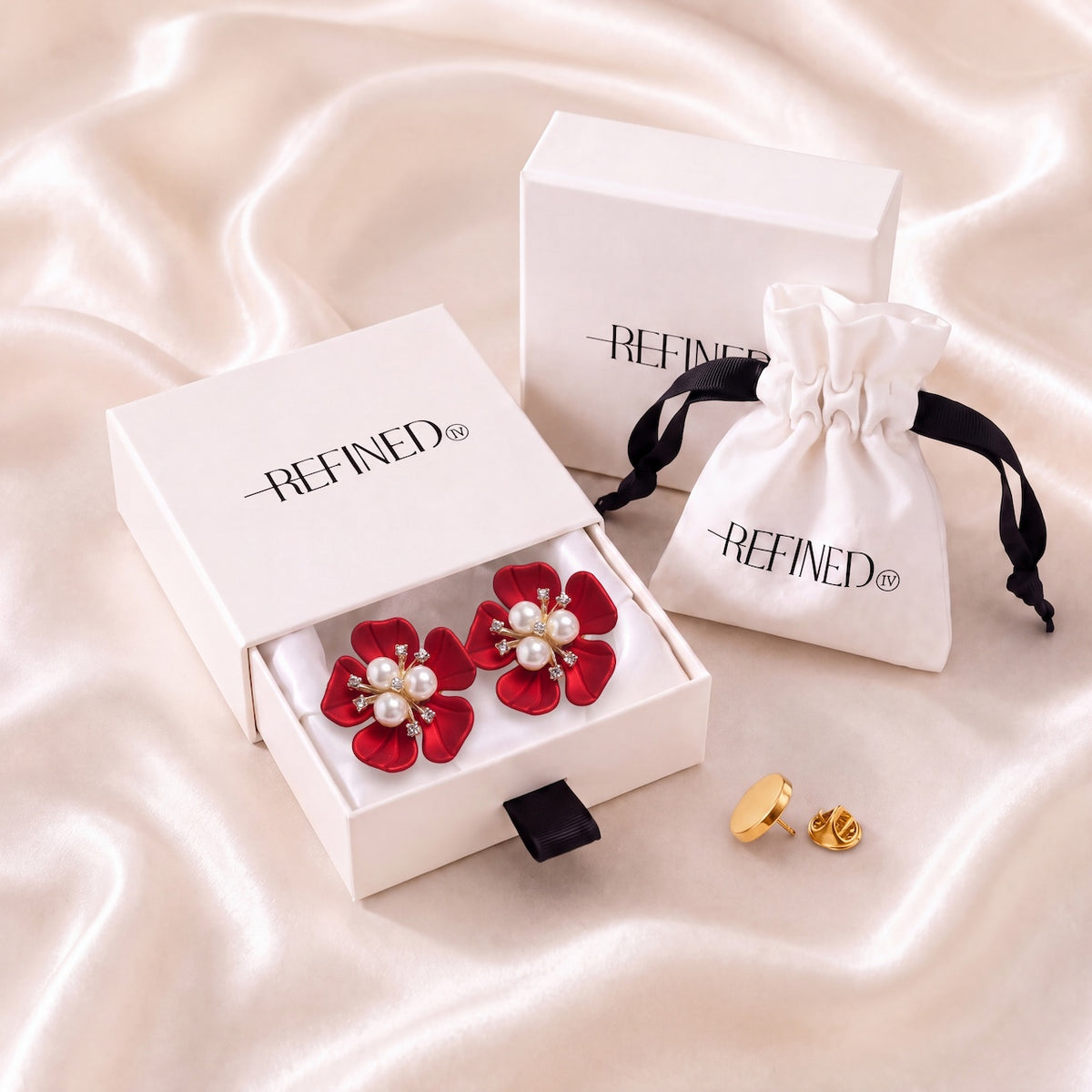 Refined by JV crimson flower button covers with pearl centers and gold-tone finish, displayed in a signature gift box.