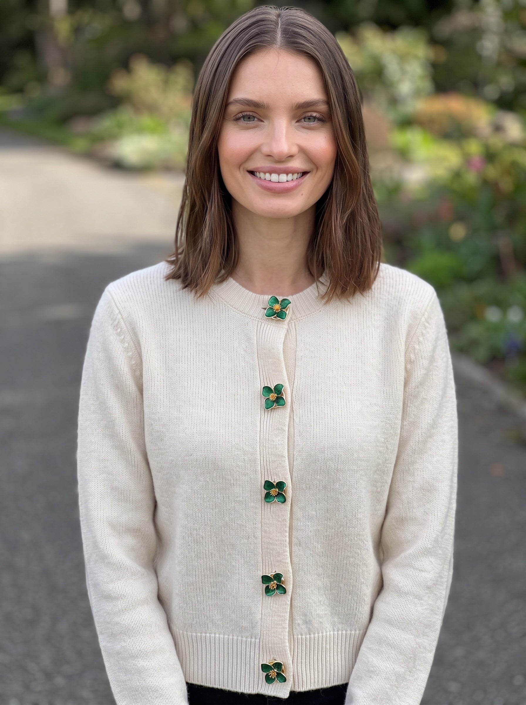 Refined by JV emerald flower button covers worn on a cream cardigan, featuring gold-tone finish and vintage style.