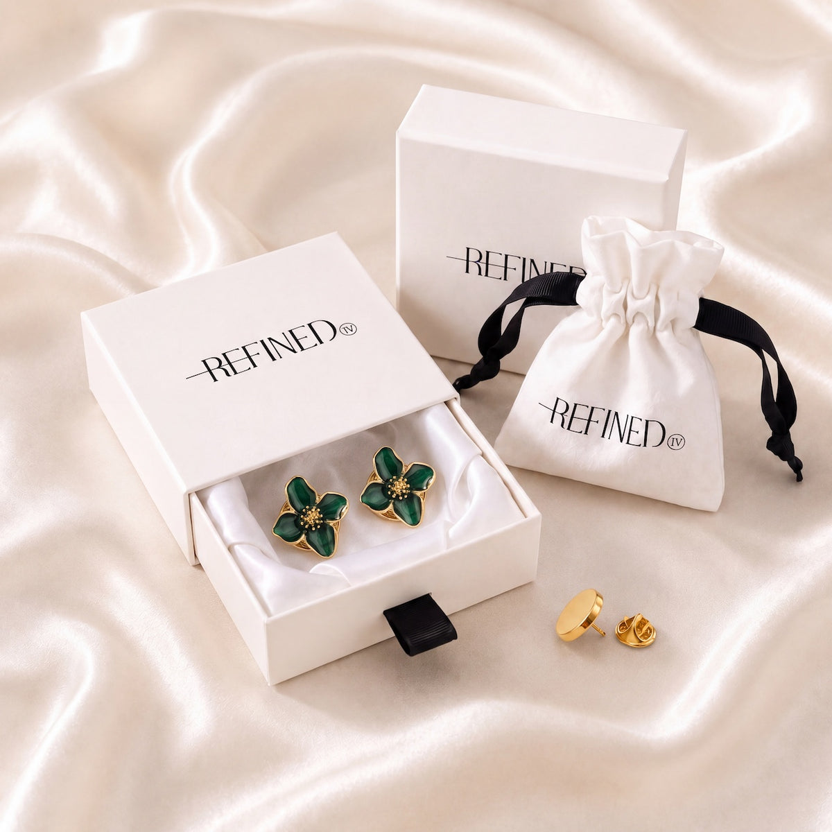 Refined by JV emerald flower button covers with gold-tone finish in a signature gift box with a drawstring pouch.