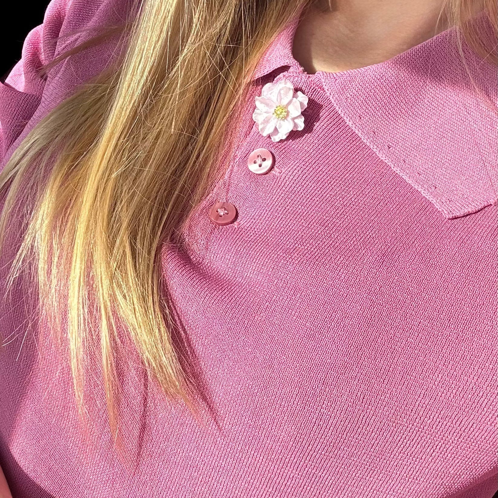 Refined by JV blush lavender camelia button cover pinned to a pink knit polo shirt collar