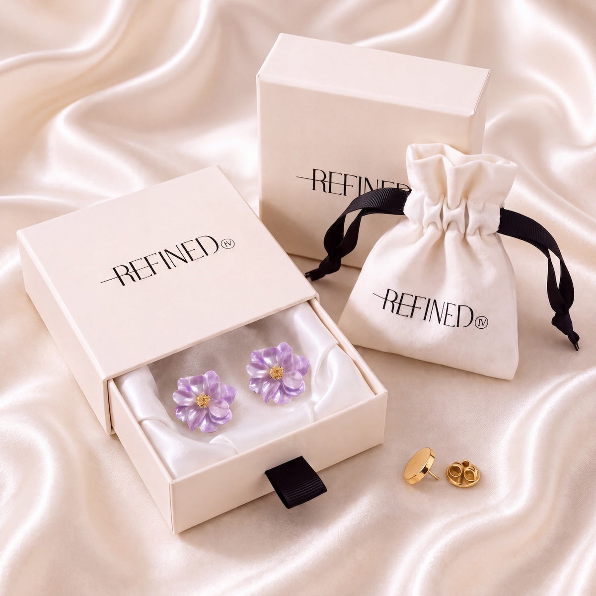 Refined by JV blush lavender camelia button covers with gold-tone centers, presented in a signature gift box and pouch.