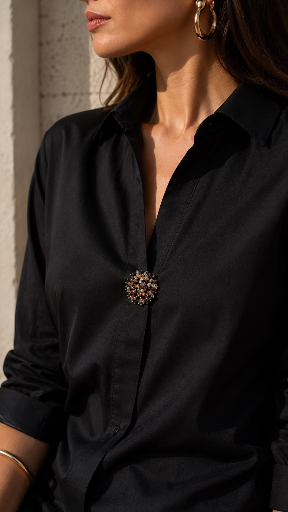 Refined by JV Nocturne gold-tone button cover worn as a decorative brooch on a black shirt