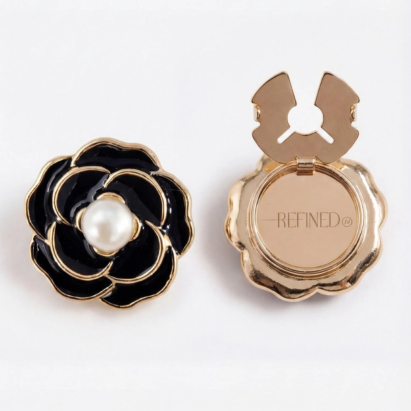 Refined by JV Noir Camélia button covers featuring black enamel flower petals, gold trim, and a central pearl accent.