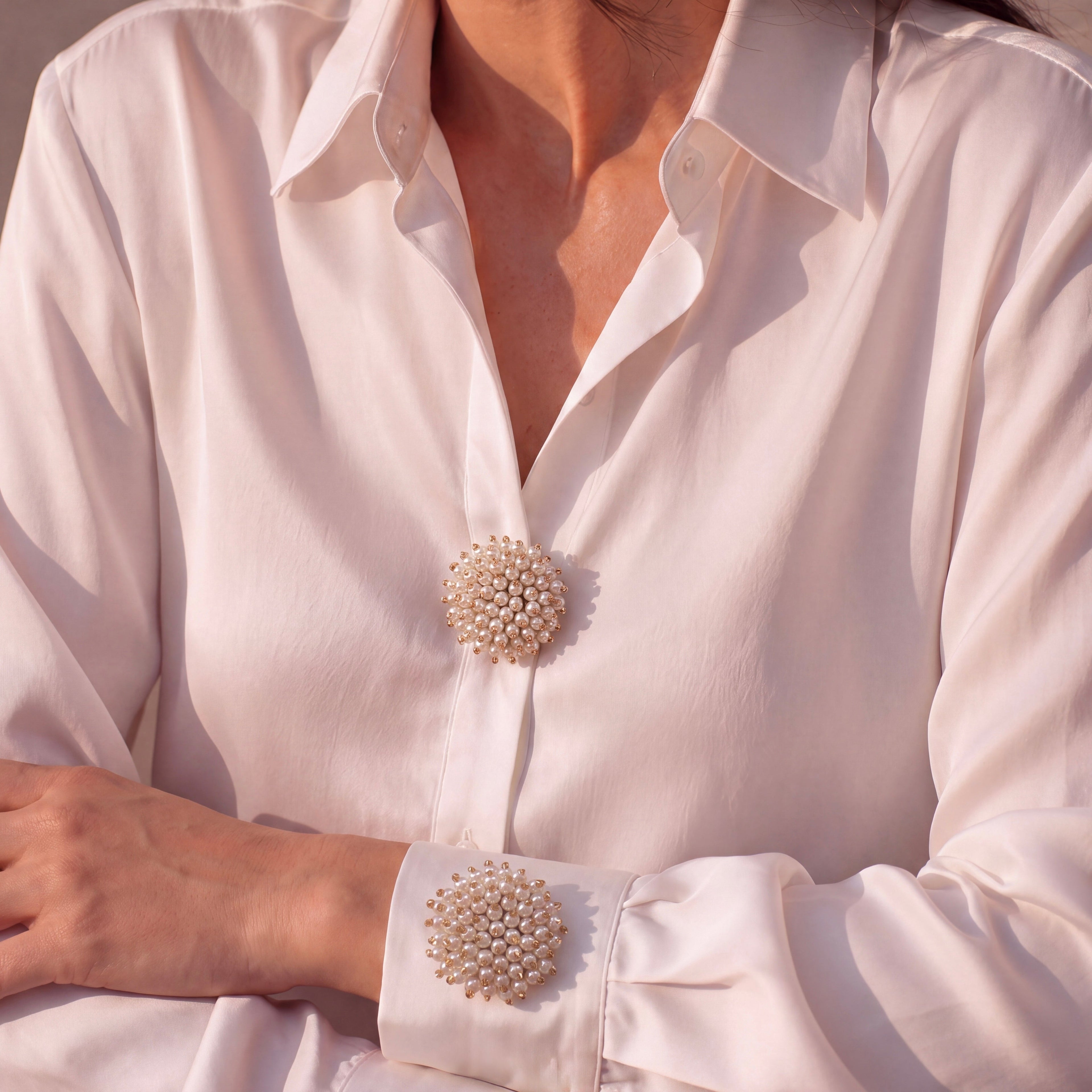 Refined by JV Pearl Cloud button covers in gold-tone metal with pearl clusters worn on a white shirt cuff and placket