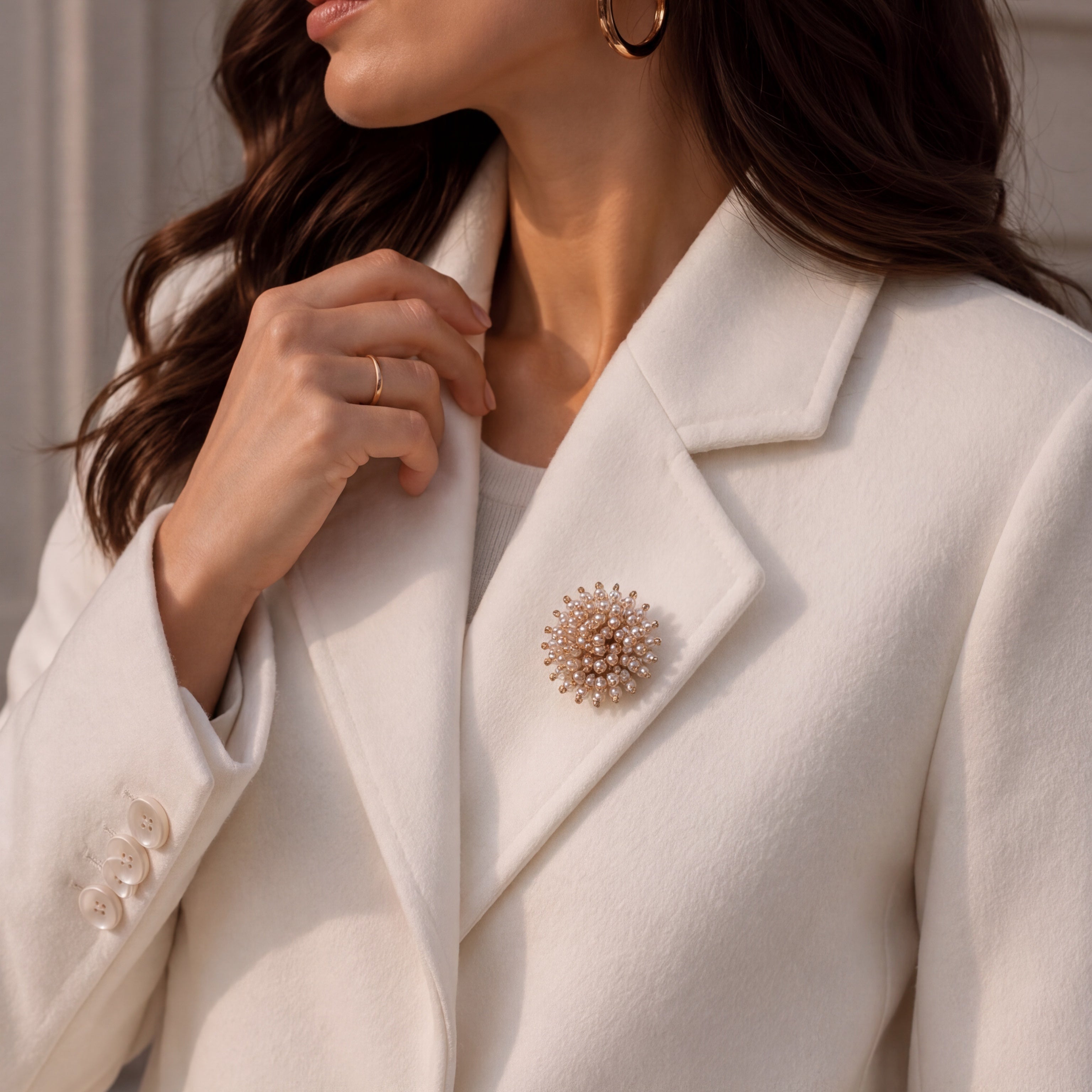 Refined by JV Pearl Cloud button cover worn as a brooch on a white blazer, featuring a cluster of small pearls.