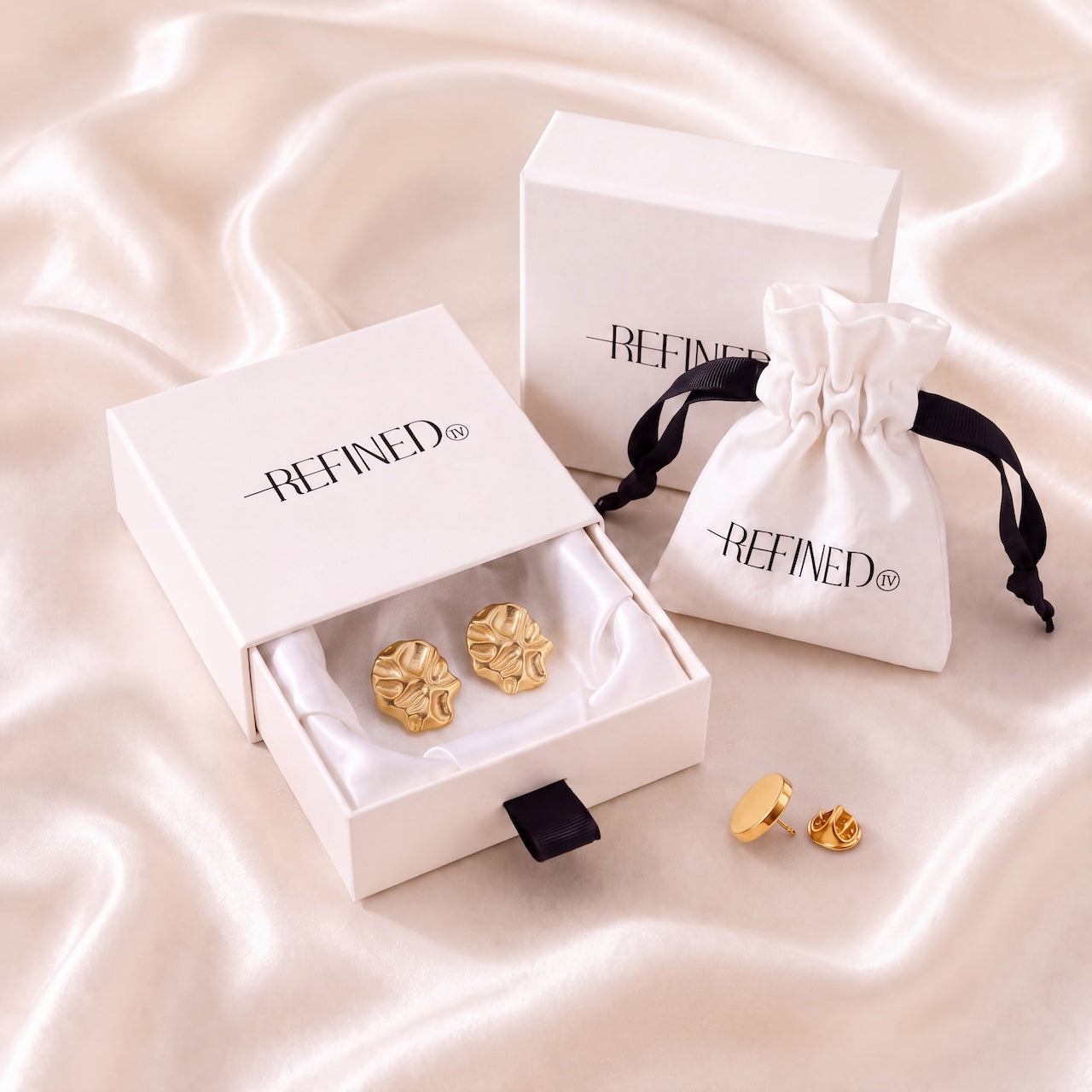 Refined by JV gold-tone sculpted button covers with pin, presented in a signature gift box and travel pouch.