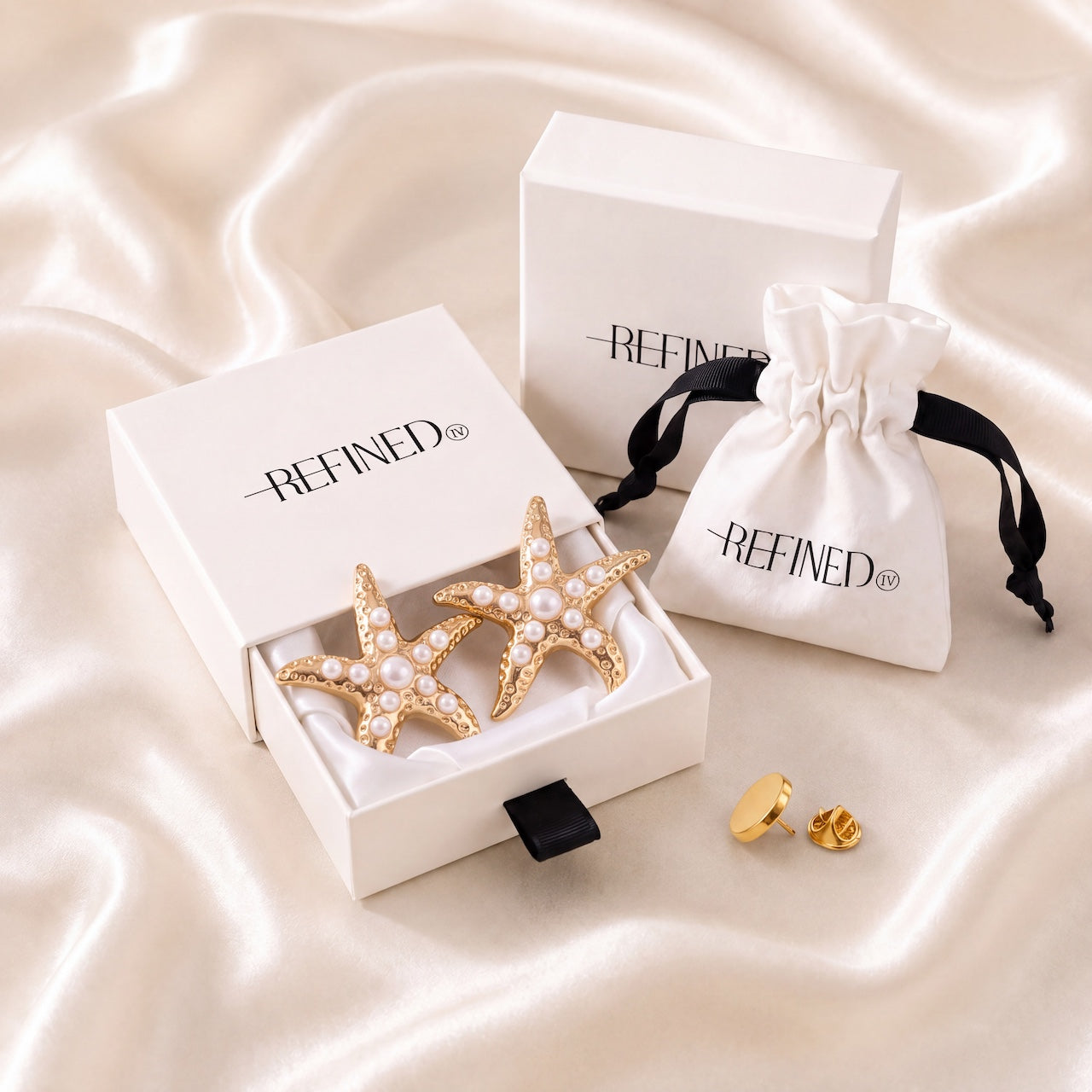 Refined by JV gold-tone starfish button covers with pearl accents in a gift box with a travel pouch and pin.